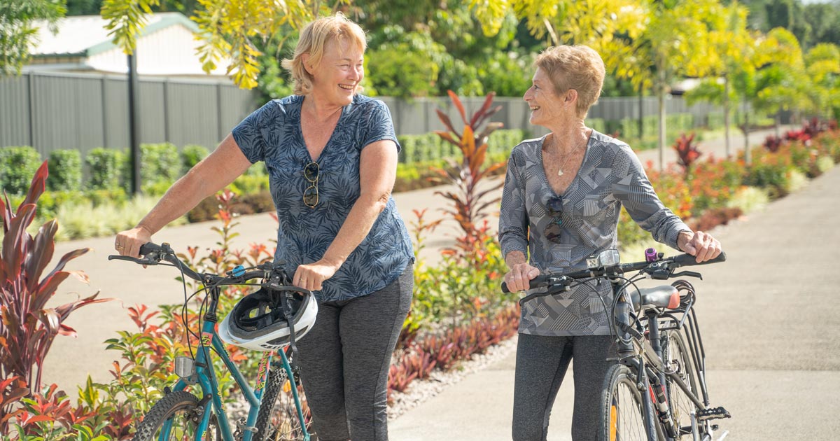 Two GemLife residents enjoying a bike ride near their GemLife resort.